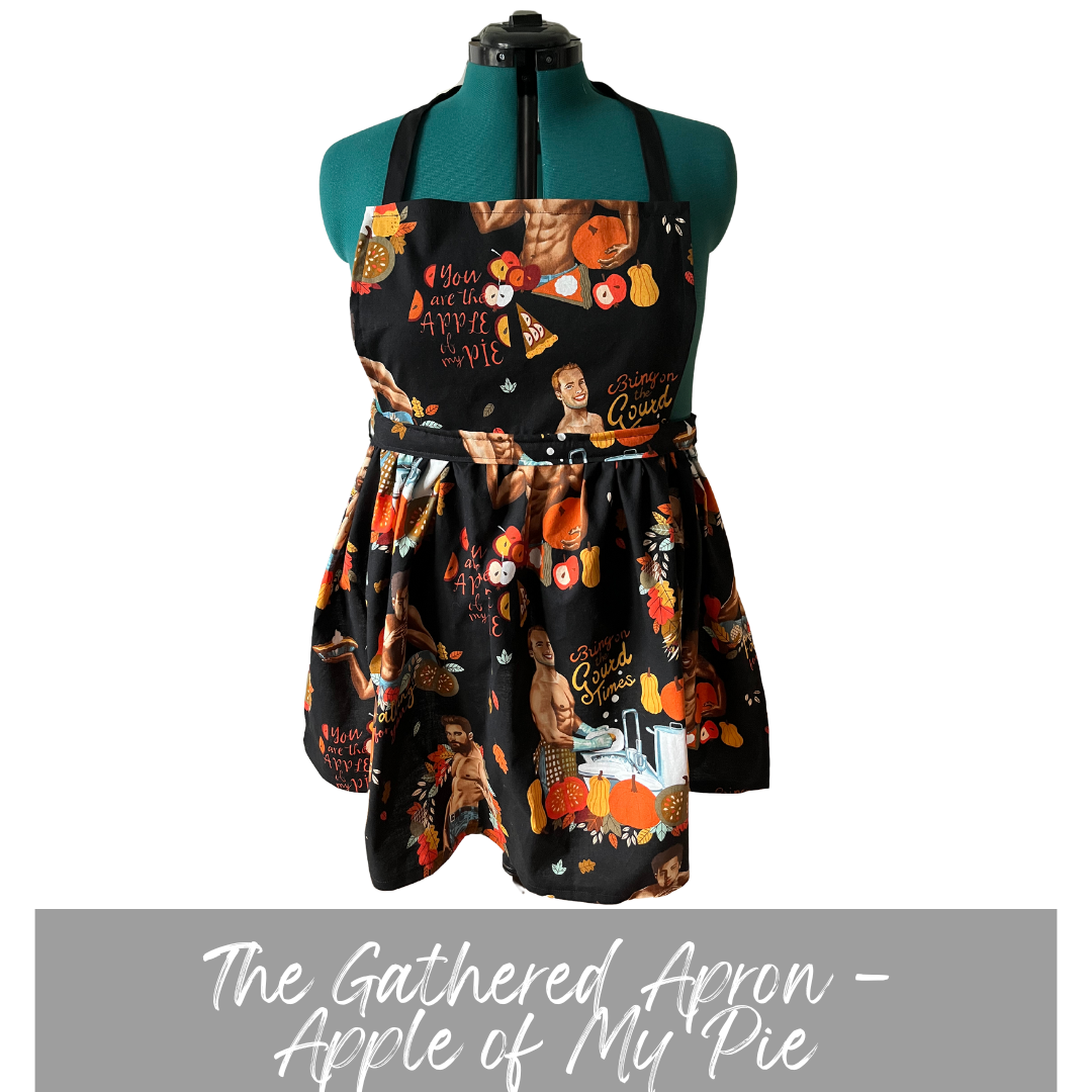black apron with Thanksgiving themed male pinups. Casstastrophe. Shop Casstastrophe. casstastropheshop.com