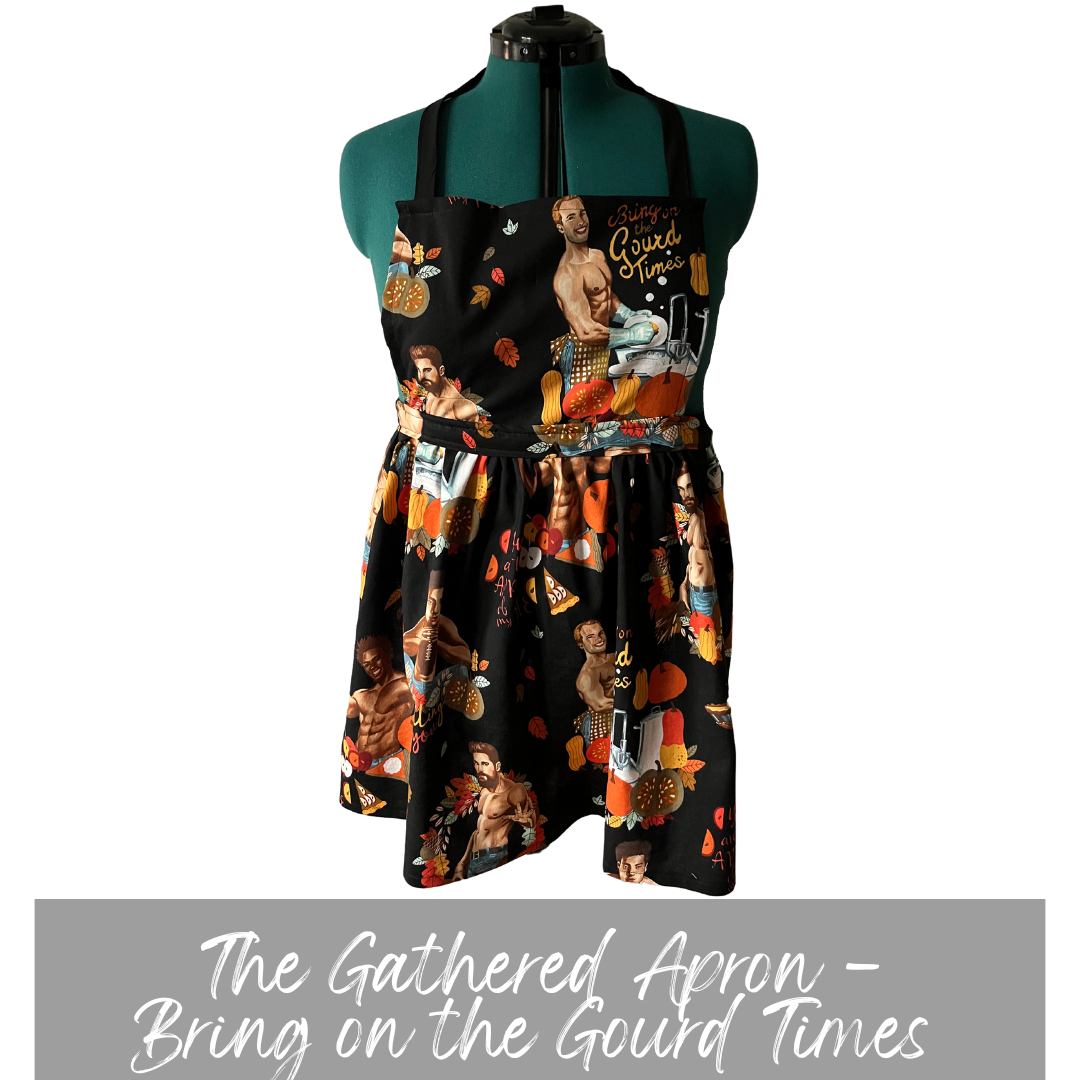 black apron with Thanksgiving themed male pinups. Casstastrophe. Shop Casstastrophe. casstastropheshop.com