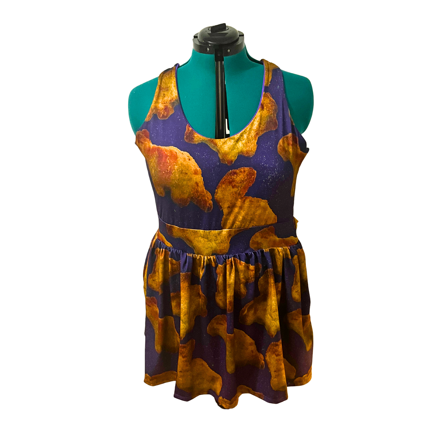 purple dress with Dino nuggets print on a mannequin in front of a white background