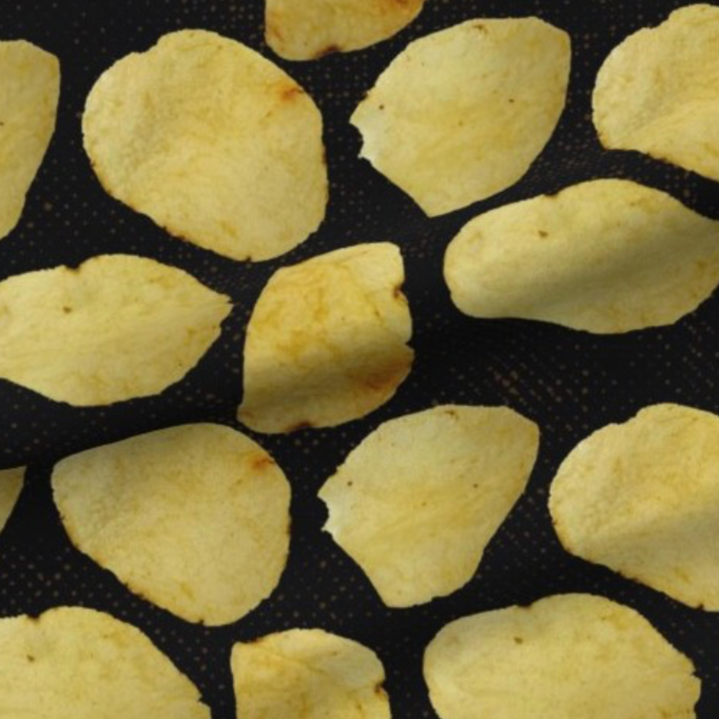 potato chips on a black background with brown speckles