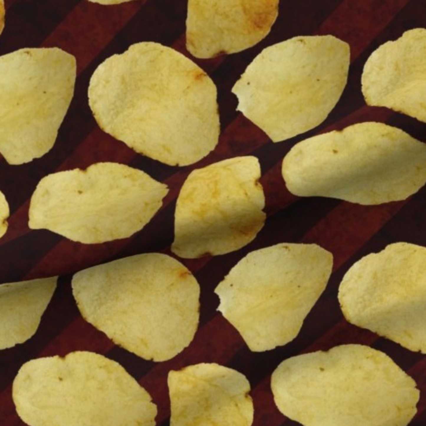 potato chips on a burgundy and brown striped background