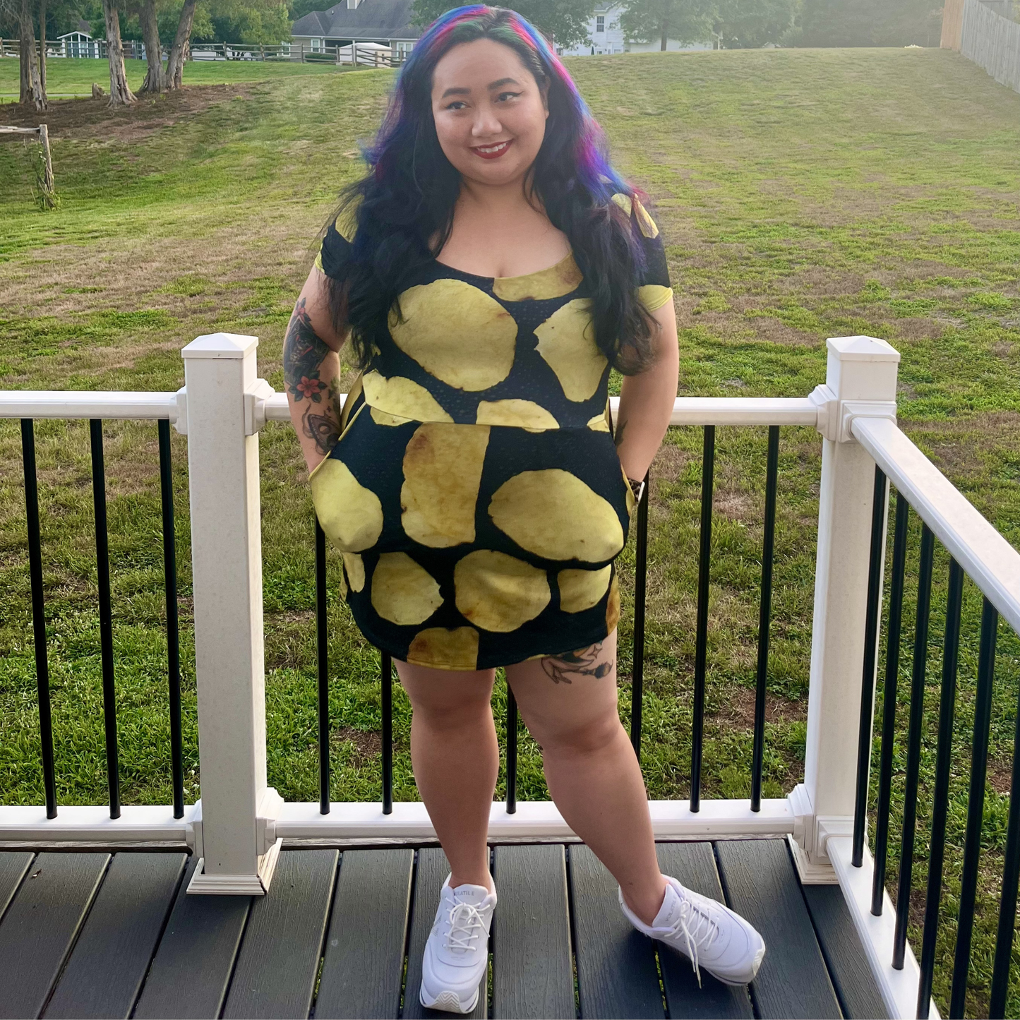 woman standing on a deck in front of a lawn wearing a potato chip print dress