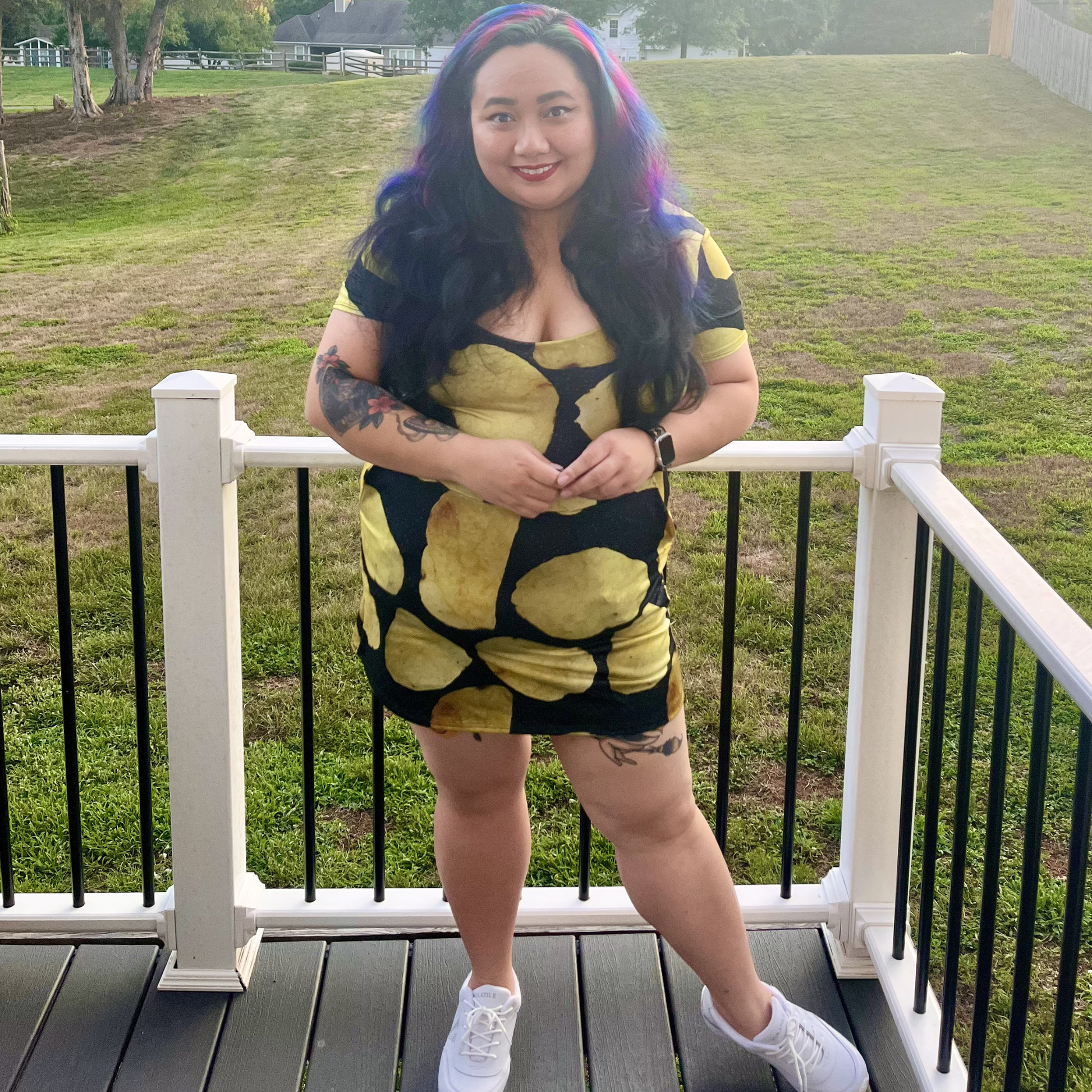 woman standing on a deck in front of a lawn wearing a potato chip print dress