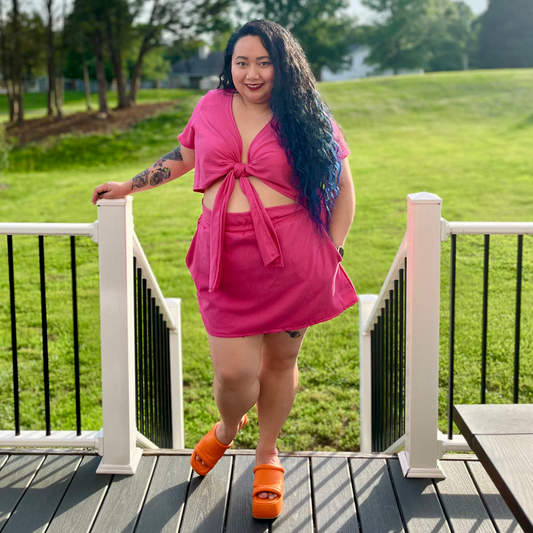 girl in backyard wearing short sleeved tie front crop top and skirt set. The Isla Set. Casstastrophe. Shop Casstastrophe. casstastropheshop.com