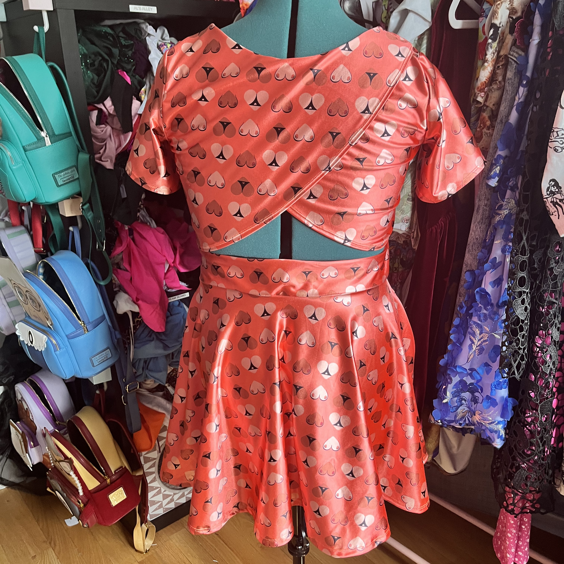 Orange printed dress on a mannequin showing the back detail